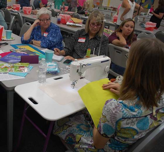 Alyssa teaching a group about free motion quilting